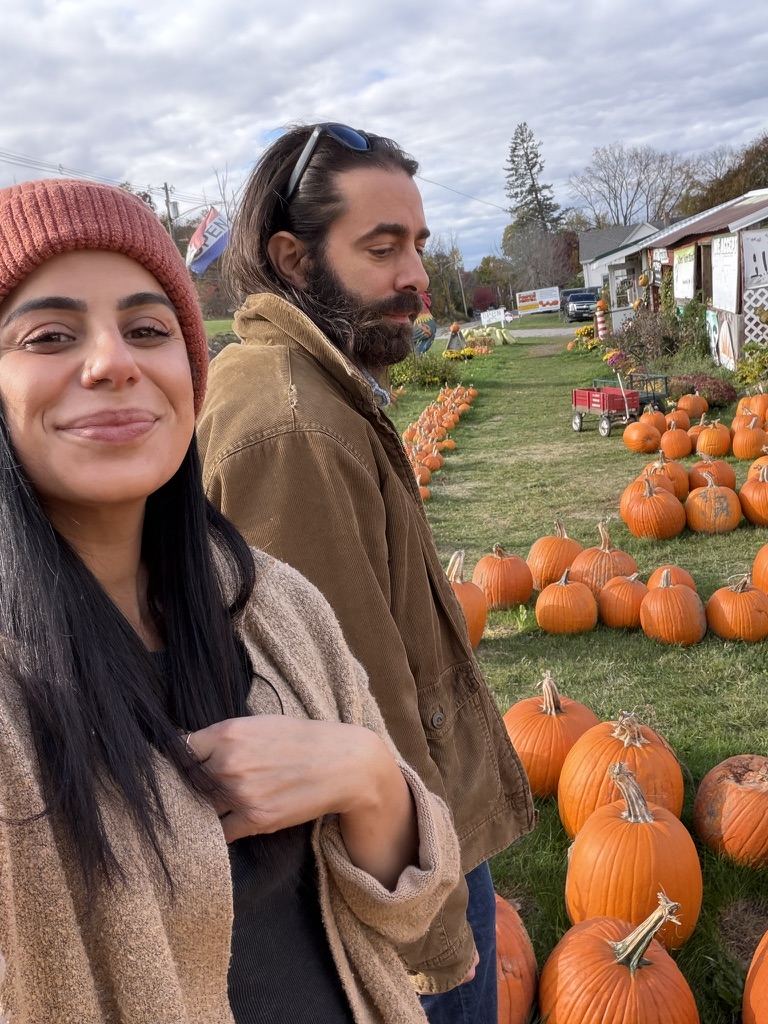 Ken and Emily among pumpkins in fall
